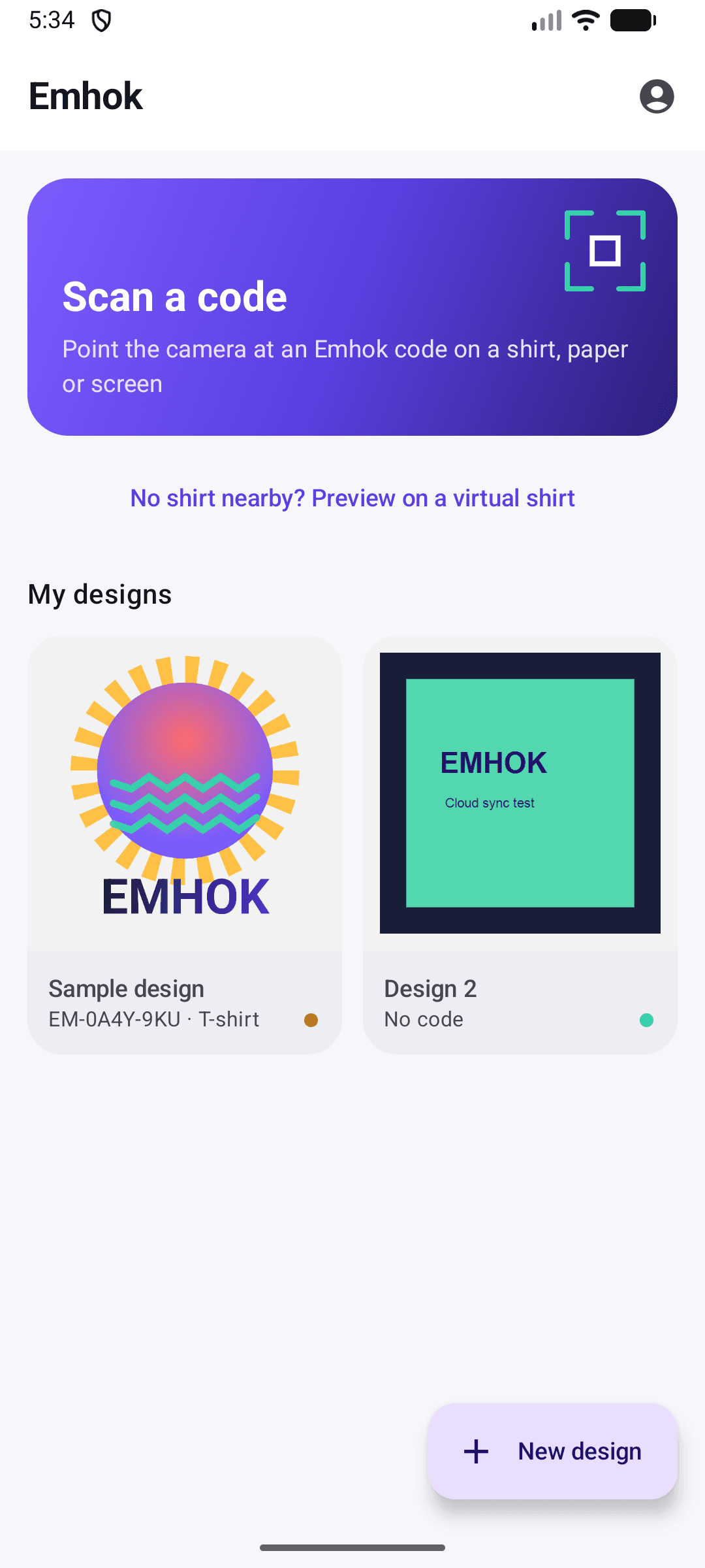 Emhok home screen with a Scan a code card, a link to preview on a virtual shirt, and two saved designs.
